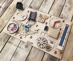 an assortment of wooden toys on top of a wooden table with scissors and other items