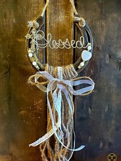 a door hanger with the word blessing hanging from it's side on a wooden door