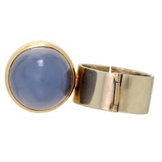 This stunning ring is a work of art that combines the natural beauty of rhodonite and blue chalcedony with the elegance of 14-karat bicolor gold. The design is modernist, with a wideband hinged structure that makes it easy to wear and remove. The ring is truly eye-catching, with a unique blend of colors and shapes that will make a bold statement.    Despite its age and wear, the ring is in very good condition and has clearly been well-cared for over the years. Its style is characteristic of the Blue Chalcedony, The Natural, Gold Ring, Natural Beauty, Gold Rings, Ring Size, Size 7, Ring, Gold