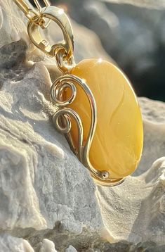 Pendant material and details : * White landscape Amber and Gold-plated Sterling Silver  * Stone : Natural Baltic Amber * Silver hallmark :Ag 925 * Pendant length : 5,5 cm * Pendant width: 3,5cm * Pendant weight: 13,0  g *Color :  White , Yellow Luxury Yellow Cabochon Jewelry, Luxury Amber Oval Necklace, Baltic Amber Gemstone Necklaces, Luxury Amber Necklace With Polished Finish, Elegant Yellow Cabochon Necklace, Luxury Amber Necklaces For Anniversary, Luxury Amber Necklace For Anniversary, Amber Cabochon Oval Pendant Jewelry, Amber Citrine Cabochon Jewelry