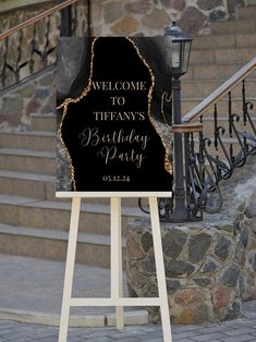 a welcome sign for a birthday party in front of some stairs and steps with a lamp post