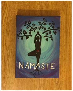 a painting of a woman doing yoga in front of a tree with the words namaste on it