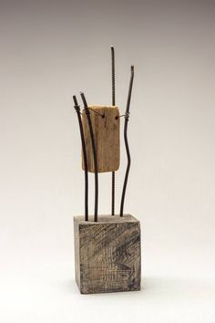 a sculpture made out of wood and wire with two sticks sticking out of the top