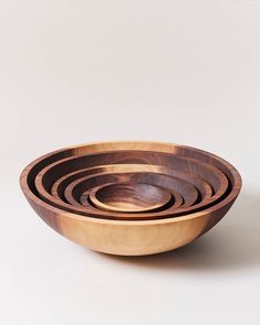 four wooden bowls stacked on top of each other