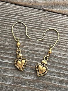 These gold Milagros earrings have a faceted pyrite stone on gold filled chain. The heart is gold finished Pewter. Brass Heart Drop Earrings, Heart-shaped Jewelry With Ear Wire For Gifts, Symbolic Nickel-free Plug Earrings As Gift, Symbolic Nickel-free Plug Earrings For Gifts, Heart-shaped Spiritual Brass Jewelry, Symbolic Hypoallergenic Drop Earrings, Spiritual Heart-shaped Brass Jewelry, Hypoallergenic Symbolic Drop Earrings, Hypoallergenic Brass Earrings As A Gift