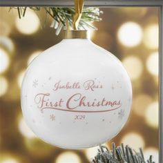 a white ornament hanging from a christmas tree