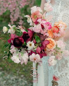 a bride holding a bouquet of flowers in her hands