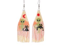 the earrings are decorated with beads and beadings, including an image of two cats