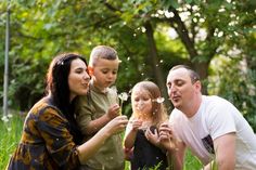 a family blowing dandelions in the grass with words learn2 teach above them