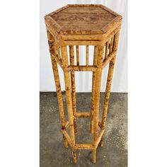 a small wooden table sitting on top of a cement floor