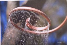 a close up of a shower head with water droplets on it