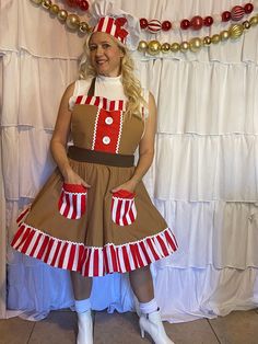 a woman dressed in a christmas themed costume posing for the camera with her hands on her hips