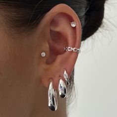 a close up of a person with ear piercings on their left and right sides