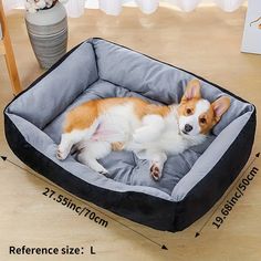 a small dog laying on top of a gray and black pet bed with measurements for it's size