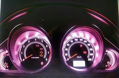 two speedometers are shown in the dark