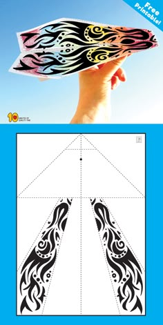 an image of a hand holding a paper with the shape of a butterfly on it