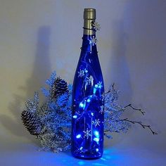 a blue bottle with christmas lights in it