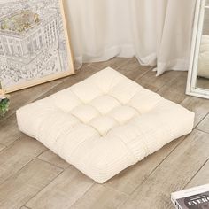 a white mattress sitting on top of a wooden floor