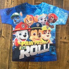 “Paw Patrol On A Roll” Jersey Fabric T Shirt, Never Worn. Size 6, Appropriate Sizing For 5/6 Year Olds Casual Printed T-shirt For Playtime, Casual Printed T-shirt For Play, Fun Printed Blue Shirt, Fun Blue Printed Shirt, Multicolor Shirt With Graphic Print For Playtime, Multicolor Graphic Print Shirt For Playtime, Short Sleeve Printed Tops For Playwear, Printed Short Sleeve Tops For Playwear, Printed Short-sleeve Tops For Playwear