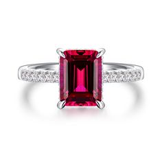 Crafted with meticulous precision, this ring showcases the deep red beauty of the lab-grown ruby, symbolizing love and passion. The vibrant hue of the ruby captures attention and adds a touch of drama to the design. The side stones, carefully selected to complement the ruby, enhance its brilliance and create a mesmerizing display of light. The elegant setting ensures that the gemstones are securely held while allowing maximum light to pass through, enhancing their fiery glow. Whether it's a roma Engagement Ring With Hidden Halo, Romantic Proposal, Ruby Engagement Ring, Jewelry Workshop, Elegant Sets, Hidden Halo, Engraved Items, Ruby Ring, Love Symbols