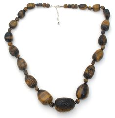 Statement Jewelry - This is a substantial vintage knotted brown tiger's eye sterling silver necklace with fabulous hand carved beads. It is 30" long, which includes the 2.5" extension, so necklace can be worn from 27.5" to 30" in length. Beads are hand knotted and vary from slightly over .25" to 1.25" in diameter. It is hallmarked 925, weighs 300 grams and signed Barse. Adjustable Carved Brown Necklace, Artisan Brown Single Strand Jewelry, Spiritual Brown Single Strand Jewelry, Spiritual Brown Carved Necklace, Brown Necklaces With Polished Oval Beads, Spiritual Brown Necklace With Large Beads, Brown Single Strand Necklace, Brown Carved Round Beads Necklaces, Brown Oval Beaded Necklaces Hand-strung