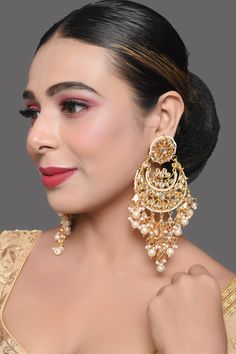 Super versatile kundan embellished pearl beaded Chandbali earrings , one of our absolute bestsellers! composition : Metal copper alloy, Synthetic Pearls,  Work : kundan with meenkari on back side  measurement  Length - 5.2in, Width - 1.6in closure- push back Care Instruction  Spot-Cleaning only. Store in a  pouch& box. Keep away from fragrance and water. Kundan Earrings Gold, Kundan Chandbali, Chandbali Earrings, Kundan Earrings, Back Jewelry, Wedding Jewelry Earrings, Copper Earrings, Ethnic Jewelry, Wedding Earrings