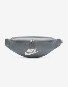 Nike Heritage Waist Pack. A Comfortable And Easy To Adjust Strap Makes The Nike Heritage Waist Pack A No Brainer For Everyday Trips. The Main Compartment Provides Secure Storage For Your Phone, Snacks Or Wallet While The Smaller Accessories Pocket On The Backside Helps Keep Things Like Your Keys, Travel Info Safe And Close At Hand. The Buckle Snaps Together In The Middle Of The Strap For A Comfortable, Easy-To-Adjust Fit. The Bag Can Be Worn At Your Waist, Across Your Body Or Over Your Shoulder. Dual-Zipper On The Front Pocket Provides Easy Access To Larger Items. Dual-Zipper On The Back Keeps Smaller Items Stored Securely. 16"l X 4"w X 6"h. Volume: 3 L. 100% Nylon. Spot Clean. Imported. Hip Pack, Pack Bag, Trendy Shoulder Bag, Adjustable Bag, Travel Info, Waist Bags, Waist Pack, Small Accessories, Nike Sportswear