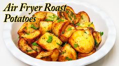 a white bowl filled with fried potatoes on top of a table next to the words air fryer roast potatoes