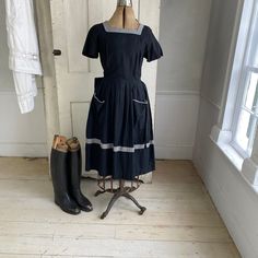 Hello and welcome to the Textile Trunk! Please follow us on Instagram we are @textiletrunk ~ ~ A charming vintage French dress dating around the 1940s! I just love this dress! It is a lovely cotton, and it has lovely simple but striking details (see photos). It zips up the side, and has a great pleated waist with some damage (see condition details). This dress features two super cute pockets on the front and a belted waist. Super simple construction, no shoulder padding, just lovely A line and b Vintage French Dress, Textured Coat, Workwear Vintage, French Dress, French Fabric, Clothing And Textile, Cotton Fashion, Antique Clothing, Cotton Coat