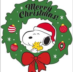 a snoopy christmas wreath with the words merry christmas on it and a dog wearing a santa hat