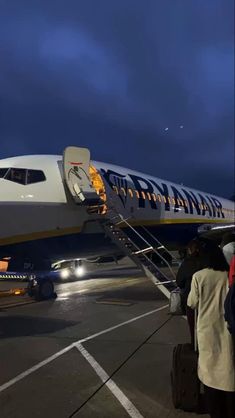 people are boarding an airplane at the airport