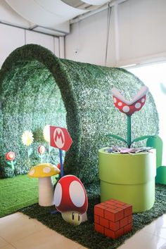 some plants and mario mushroom decorations in a room