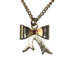 Vintage gold tone and red rhinestone bow pendant necklace. The pendant is on 18 inch chain with spring ring clasp. Cute gift for her. DETAILS: ☼ Pendant approximately 3/4 by 3/4 inches. ☼ Chain approximately 18 inches. ☼ Approximately 4.3 grams total weight. ☼ ☼ ☼ ☼ ☼ ☼ ☼ ☼ ☼ ☼ ☼ ☼ ☼ ☼ ☼ ☼ ☼ ☼ ☼ ☼ ☼ PLEASE NOTE: ☼ Different items on SALE everyday! Check back often to take advantage of these bargains! ☼ FREE DOMESTIC SHIPPING on purchases of $35 or more. Combined shipping is still available to do Vintage Ribbon Necklace For Gift, Vintage Gold Jewelry With Ribbon, Bow Pendant, Cute Gifts For Her, Palm Coast, Rhinestone Bow, Red Rhinestone, Cute Gift, Spring Rings