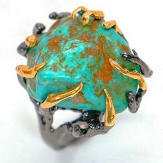 DESCRIPTION: 100% genuine natural Turquoise from Arizona, USA. This ring is truly one of a kind jewelry piece of art. Using a large 100% genuine Turquoise Nugget Stone as a center piece. In an unique design in the making of this exceptional ring.  * Stunning Beautiful and Unique*  METAL: 925 Sterling Silver with a Gold and Black finish. Antique style, this very well can be a unisex ring.   SIZE: 7.5 CRYSTALS AND STONES: Top Quality 100% Natural and Genuine. Please note that ALL the Crystals and Turquoise Statement Ring, Healing Crystal Jewelry, Arizona Usa, Tourmaline Necklace, Copper Bracelet, Unisex Ring, Genuine Turquoise, Ethnic Jewelry, Natural Turquoise