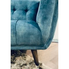 a blue chair sitting on top of a wooden floor