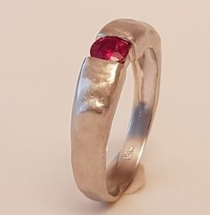 14k white gold ring set with Ruby14k white Solid Gold Textured Hammered set with 0.24carat natural Burmese ruby  14k 3.3gr. - ruby 0.24c - 980 dolarProduct description: Upper part width is- 4.5mm,lower part width - 2.5mm.ruby diameter - 3.8mmMetal 14k solid gold  weight 3.3 gr.You can also get this ring :You can get this ring also in 18k gold You can get this ring is Rose Pink and white goldYou can set this ring with other stones that suit your style and budget: Diamond, , Emerald, Blue sapphire Ring Men Gold, Hammered Ring Men, Ruby Ring Vintage, Ruby Wedding Rings, Burmese Ruby, Emerald Blue, Ruby Wedding, Zierlicher Ring, Hammered Rings