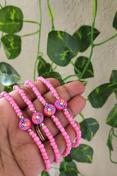 Handcrafted with love, this vibrant seed bead bracelet features a charming pink clay flower as its centerpiece. The intricate beadwork showcases a delightful mix of colors, complementing the delicate flower charm Perfect for adding a touch of playful elegance to any outfit, this bracelet is both unique and eye-catching a lovely gift for yourself or someone special. Pink Hand-strung Heishi Beads Friendship Bracelets, Adjustable Pink Beaded Necklace For Friendship, Pink Heishi Beads Colorful Beaded Bracelets, Pink Heishi Beaded Bracelets With Colorful Beads, Pink Tiny Beads Friendship Bracelets As Gift, Pink Tiny Beads Friendship Bracelet As Gift, Pink Heishi Beads Bracelet, Pink Tiny Beaded Bracelets For Gift, Pink Tiny Beads Bracelet For Beach