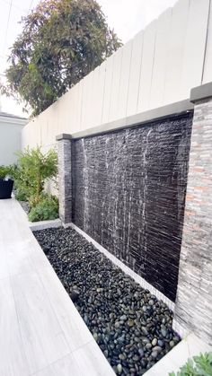 an outdoor water feature with rocks and plants