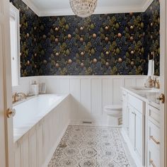 a bathroom with a chandelier hanging from the ceiling next to a bathtub