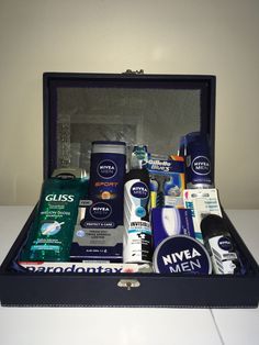 an open suitcase filled with men's grooming products on top of a table