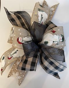 a black and white bow with snowmen on it