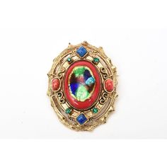 This is part of Chairish’s Costume Jewelry assortment.  This vintage set of signed Hattie Carnegie enamel clip on earrings and small pin and or pendant is reminiscent of a bygone era of Elizabethan meets byzantine influence. The colors are rich, vibrant and exquisite as are all the details and workmanship. They range from the enamel work of red, royal blue, iridescent blue and green.The rhinestones are green and the glass is red and blue. The play of colors used and the high quality of the ename Multicolor Enamel Brooch Jewelry, Elegant Enamel Jewelry With Cabochon, Elegant Oval Cabochon Brooch Jewelry, Victorian Style Metal Clip-on Jewelry, Costume Jewelry Metal Brooches For Gifts, Metal Costume Jewelry Brooches For Gifts, Elegant Multicolor Collectible Brooches, Party Jewelry With Jeweled Enamel, Multicolor Cabochon Costume Jewelry