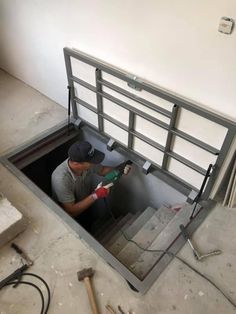 a man working in a hole with tools