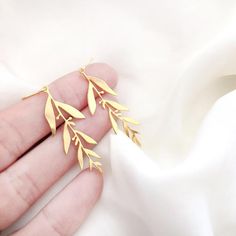 A beautiful and unique pair of dangle gold olive branch/leaf earringsThese minimalist design earrings will keep the compliment coming all year round.***Free Shipping***Size:Total length: approx. 5cm- 2" inchElement is approx. 4 x 1.5 cm- 1.6 x 0.5"inchThe earrings is handmade gold over brass.**Ear hook is made of goldfield* Nickel freeThese earrings will look great with this necklace:https://www.etsy.com/uk/listing/661117681/olive-leaves-necklace-olive-leaf-greek?ga_search_query=olive&ref=shop_i Minimalist Leaf-shaped Jewelry With Matching Earrings, Minimalist Gold Leaf Earrings, Elegant Gold Plated Leaf Earrings, Leaf Earrings Gold, Botanical Minimalist, Leaves Necklace, Olive Leaves, Wolf Jewelry, Gold Leaf Earrings