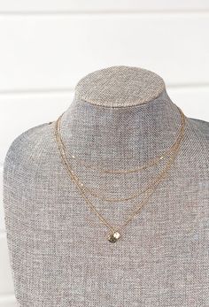 This cool link necklace is shaped from three layers of gold chain with a double coin pendant. Layered gold necklaces are an easy accessory to dress up an outfit. This necklace is has 3 layers, so you don't have to worry about knots when stacking you're necklaces! The Amaya Layered Necklace at Groovy's - A 3 layered gold neck, each strand having a different chain and texture that gives it a unique look. Add with any top in your closet for a put together look! 3" of adjustable length Typically shi Layered Gold Necklaces, Gold Necklace Layered, Gold Necklaces, Three Layer, Affordable Jewelry, Layered Necklace, Coin Pendant, 3 Layers, Link Necklace