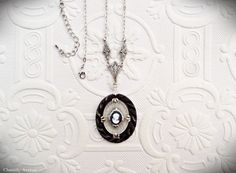 "A stunning Camphor glass cameo necklace made from three rare vintage cabochons and silver-plated filigree. It makes the perfect handmade women's gift for anyone who loves vintage style Art Deco jewelry. The pendant portion is made from a setting base of vintage molded black glass, topped with a Camphor glass cabochon, and finished with a tiny deep blue Czech glass cameo. The pendant measures 30x40mm (1.18x1.5\") and it's a very bold statement piece. Chain measures 16\" with a 3\" extension chai Handmade Victorian Antique Silver Necklaces, Handmade Antique Silver Victorian Necklace, Victorian Oval Nickel-free Necklaces, Handmade Victorian Antique Silver Necklace, Round Silver Cameo Necklace, Victorian Cameo Silver Necklace, Elegant Oval Pendant Necklace With Soldered Details, Silver Cameo Necklace, Necklace Art Deco