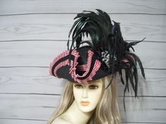 Beautiful Black faux straw pirate hat with red and white stripe pleated trim, black braid, black cocarde with a large antique silver octopus and long flowing black iridescent coque feathers. These are all-natural feather which will have some flaws so please keep this in mind. This hat is 22.5" for the inside circumference with a built-in hat sizer. Just cinch and tie. Please measure your head as I cannot make the circumference bigger. Check out my other pirate hats and other goodies in my etsy s Black Brimmed Hat For Themed Events, Pirate-themed Black Costume Accessories, Black Pirate Costume Accessories For Themed Events, Black Pirate Costume Hat With Curved Brim, Black Brimmed Costume Hat For Themed Events, Black Hat For Carnival, Adjustable Black Pirate Costume Hat, Black Adjustable Pirate Hat, Adjustable Black Pirate Hat