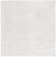 a white rug with an intricate design on the front and back side, in varying shades of gray