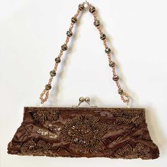 - Brand New Chocolate Brown Beaded Clutch/Evening Purse - Good Condition. - Elegant Design. - Colors: Brown with Silver Hardware. - One Small pocket inside the purse. - A Plastic Bead Chain inside, just in case you want to wear it on your shoulder. - Measures: Height 3.75" x Width 10".  (Very good size, will fit iPhone and some cards.) - Free Shipping within USA. - All Sales are Final. - My small business can't afford free shipping internationally yet. Sorry~ :P Punk Vintage, Beaded Handbag, Evening Purse, Colors Brown, Beaded Clutch, Beaded Purses, Bead Chain, Some Cards, Purse Strap