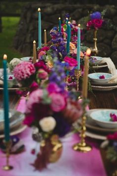 the table is set with candles and flowers